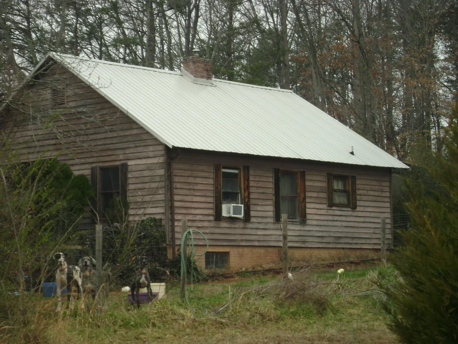 White metal roof on an old wood sided farmhouse, from a Metal Roof Installation job in Geneseo